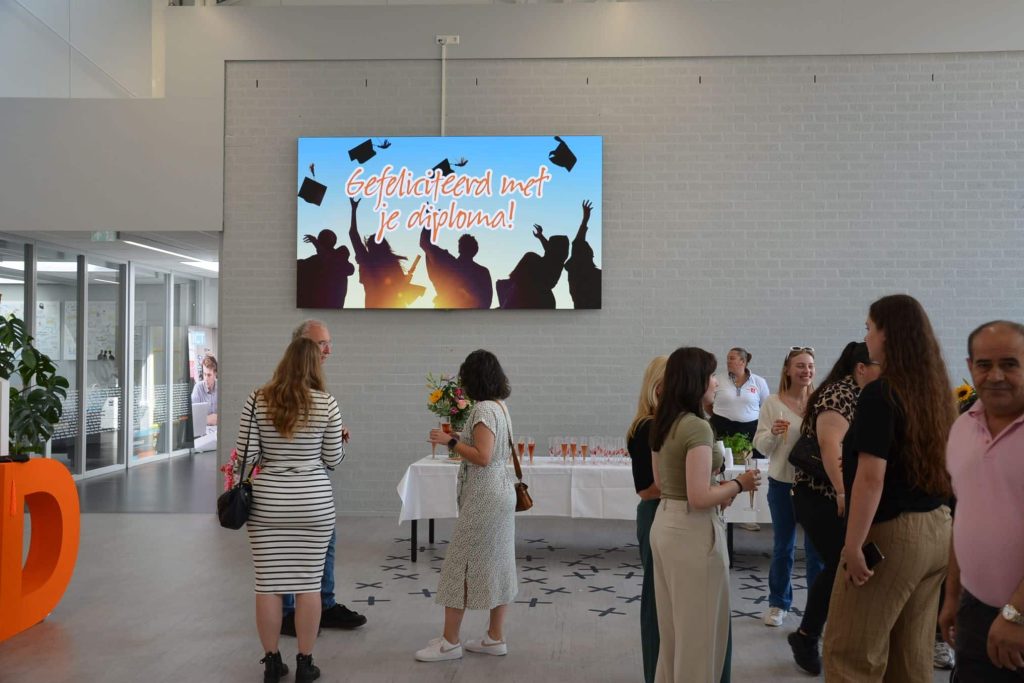 Mooi indoor LED scherm geplaatst door Limid | SMARTBoard.nl en wordt goed gebruikt op een school in Almere. Op het indoor scherm is een felicitatie van de diploma-uitreiking.